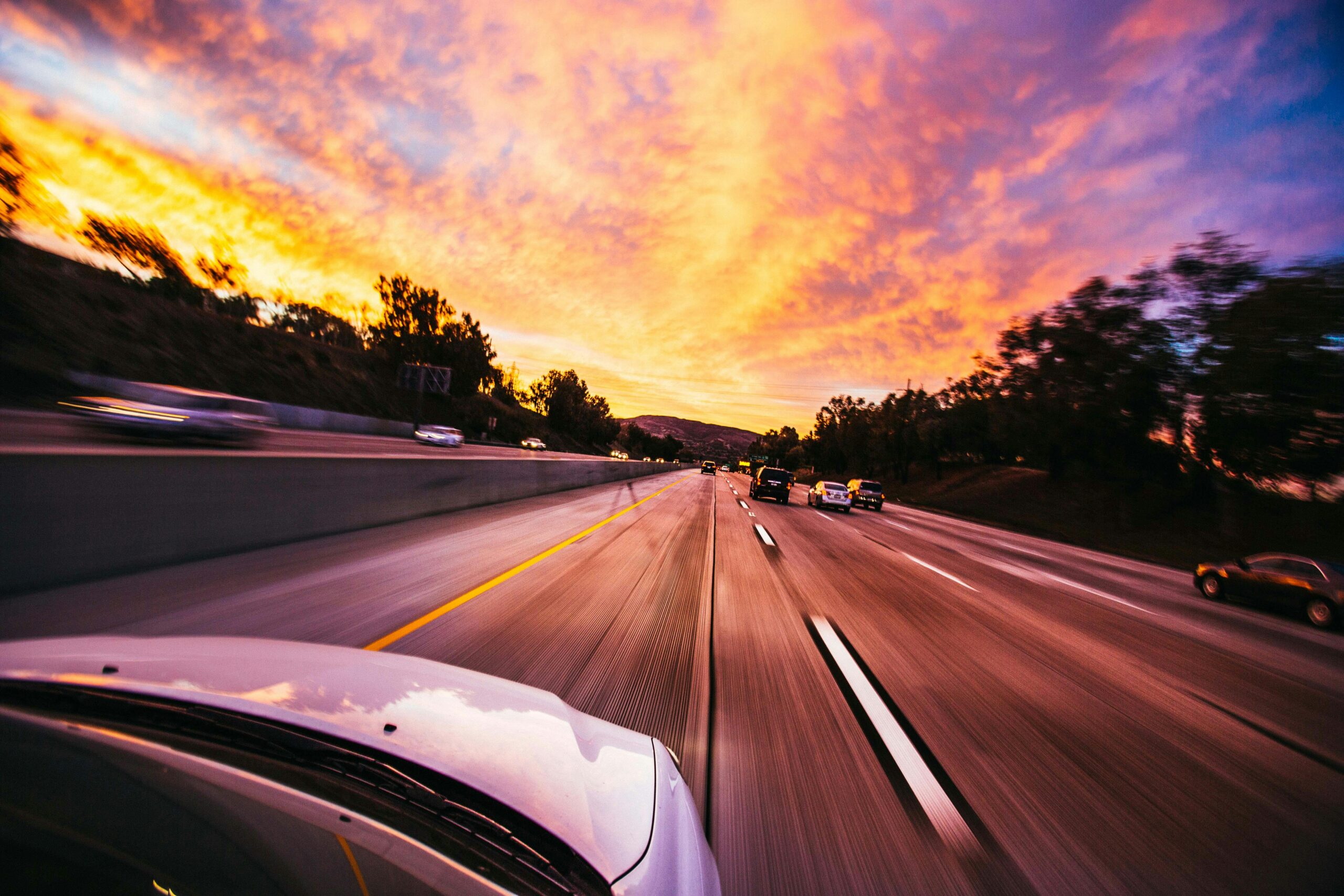 Projects Motion blur of cars speeding on an Irvine highway at sunset with vibrant skies.